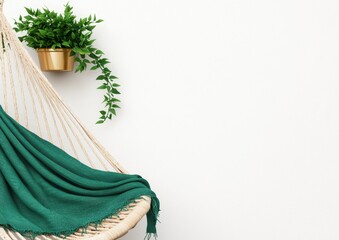 Cozy Hammock with Green Blanket and Potted Plant on White Wall