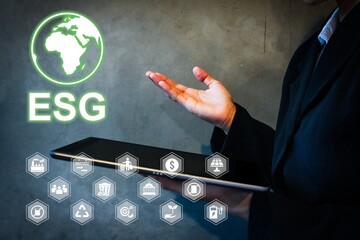 Business professional presenting ESG concept with a digital tablet. Sustainable investment,...