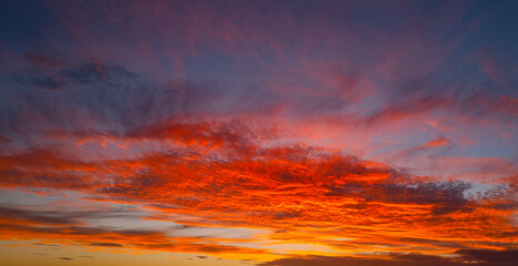 Sky at sunset. Sunrise background. Sunset through clouds on sky. Twilight sky with sunset colors. Peaceful dawn with soft light. Dramatic dusk sunset with clouds. Sunshine in clear sky.