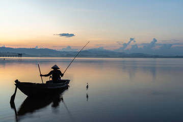 Fisherman of Bangpra Lake in action when fishing, Thailand