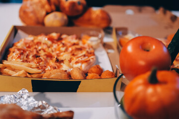 Happy young friends group having lunch at home. Asia family party eating pizza food and laughing enjoying meal while sitting at dining table together at house. Celebration holiday and togetherness.