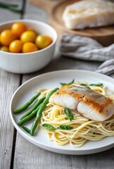 Delicious Plate of Pasta with Grilled Fish, Fresh Green Beans, and Cherry Tomatoes on a Rustic Wooden Table for Culinary Inspiration