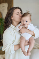 Mother kissing baby, joyful moment of bonding