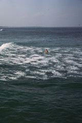 Happy wet woman surfing in the ocean