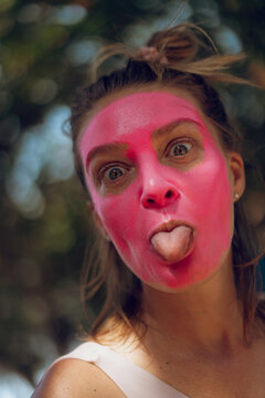 Surfer gets pink zinc sunscreen applied to her face