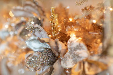 Detail of gold and silver holiday decorations on Christmas tree