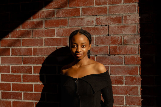 Young black women against a red brick wall