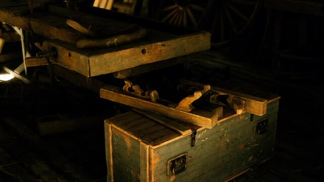 Old woodworking tools are carefully arranged on a rustic workbench, illuminated by soft light in a traditional workshop. The atmosphere reflects craftsmanship and history.