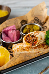 Turkish kebab tantuni served with sauce and pickles. Mersin tantuni wrap