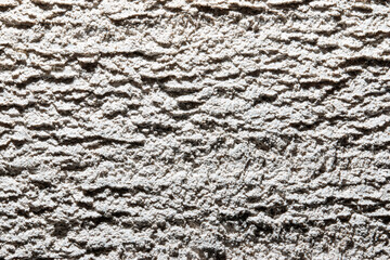 The image is a close up of a wall with a textured surface