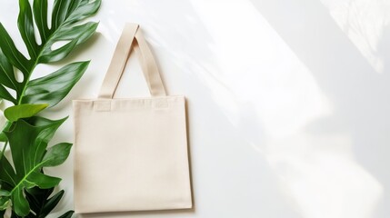 Elegant beige canvas tote bag with long handles displayed on a bright white backdrop