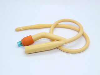 Yellow latex coated silicone catheter foley. Urinary catheter. Urinary tube with 2 lumen isolated on white background