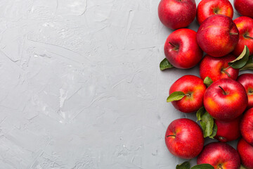 Many red apples on colored background, top view. Autumn pattern with fresh apple above view with copy space for design or text