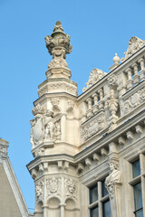 Ornate building facade showcasing intricate sculptural details, decorative elements, and large windows, epitomizing classic architectural beauty.