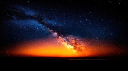 Naklejka premium The Milky Way galaxy stretches across the deep night sky