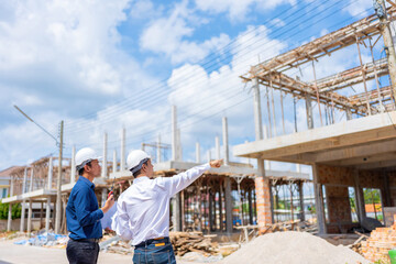 Fototapeta premium Two male Asian engineers are dedicated to improving the construction industry by designing beautiful village-style homes that offer practical options for both rent and sell.