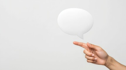 Hand holding blank speech bubble,  visual representation of communication and dialogue