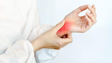 Wrist pain chronic therapy concept. Person gently massaging their wrist, suggesting care or relief from discomfort.