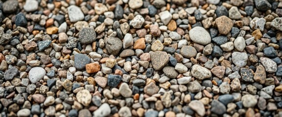 Close-up of coarse granite gravel, showing varied colors and textures, driveway, detail, rough