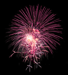 Colorful celebration fireworks isolated on a black sky background.