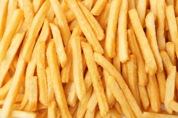 Pile of delicious French fries as background, top view