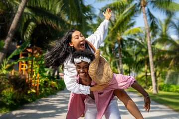 Passionate summer love on a tropical beach, young interracial couple enjoying adventure, laughter