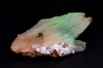 Radioactive gypsum crystal glowing green fluorescence natural mineral rare specimen.