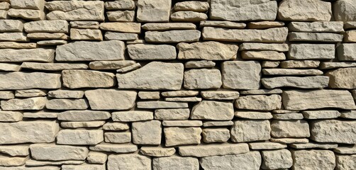 Rustic stacked stone wall, varying shades of grey and brown, rough texture, stone wall, stacked stone, aged