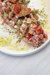Traditional Cretan summer salad - Barley bagel with grated tomatoes, feta cheese and virgin olive oil