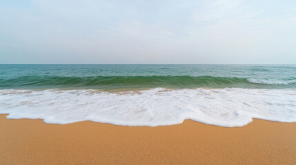 Fototapeta premium serene beach landscape featuring gentle waves lapping against golden sand, evoking sense of tranquility and relaxation