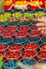 Different coloured berries on sale at a market stall