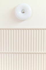 Minimalist white ceiling with round light fixture and textured linear design, creating clean and modern aesthetic