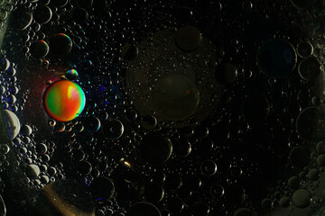 Dark Abstract Macro Bubbles with Light Reflection. Close-up macro shot of black liquid bubbles with a mesmerizing light reflection. Perfect for science, technology, and abstract backgrounds.