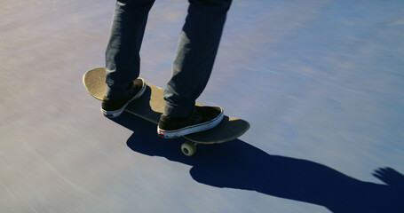 Skateboard, feet and person training for trick for outdoor hobby, activity or challenge at park. Sports, shoes and legs of skater with sneakers for skating with skills learning for competition. © peopleimages.com