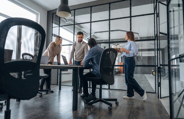 Talking, discussion of the plan. Professional workers are in the modern office together
