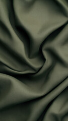 Fototapeta premium Wrinkled olive green textile forming soft curves and natural shadows for elegant phone wallpaper use.