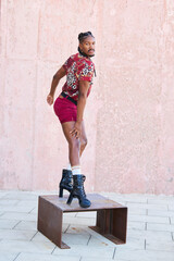 Young androgynous dancer posing on a metal platform