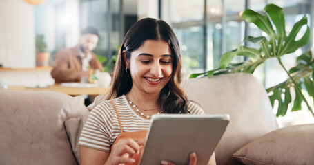 Woman, relax and happy on sofa with tablet, social media and ebook for weekend chill in home. Person, reading or tech in living room for streaming subscription, email notification or download new app