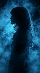 Obraz premium : Silhouette of a Person with Wavy Hair Against a Blue Misty Background
