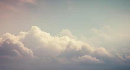A view of soft fluffy clouds in a pastel colored sky