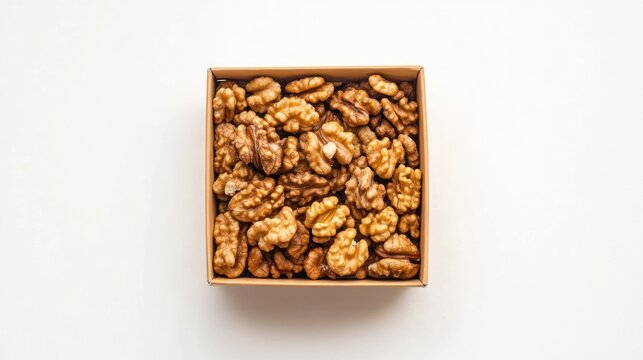 Walnuts in a cardboard box on white background. Possible use food photography