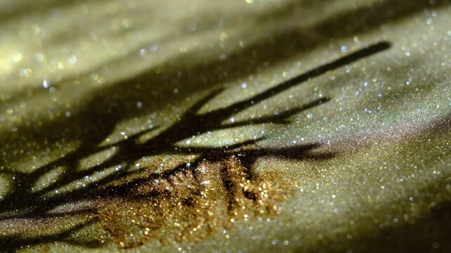 Bizarre shadow on golden glitter background. Visual illusion. Eccentric style. Cinematic atmospheric mood. Surreal