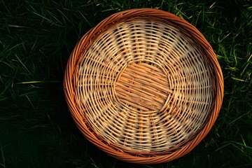 Fototapeta premium Round Wicker Basket on Green Grass Summer Picnic