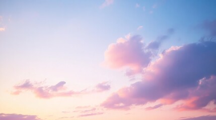 Obraz premium A radiant sky, tinged with soft pink hues, invites calm as fluffy clouds drift across the expansive canvas of dusk.