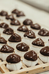 Marshmallow sweets in the form of mushroom in wooden tray on industry. Brown-white boletus.