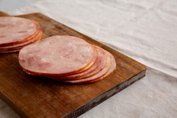 Organic Smoked Cold Cuts Deli Meat Ham on a wooden board, side view. Copy space.