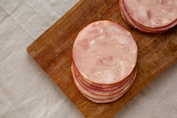 Organic Smoked Cold Cuts Deli Meat Ham on a wooden board, top view.