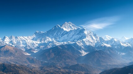 Fototapeta premium Majestic snow-capped peaks of a vast mountain range stand majestically against a clear blue sky, showcasing nature's grandeur.