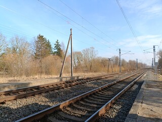 Two way railroad tracks in countryside. Two railway tracks. Sunny day. Countryside. Fields and...