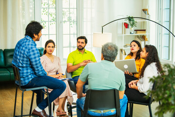 Diverse Indian startup team collaborating on mental health workplace wellness in a business meeting